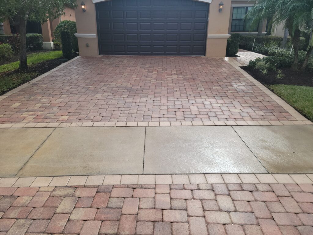 Reddish cut stone pattern in front of a garage, preserved by Naples paver sealing services.